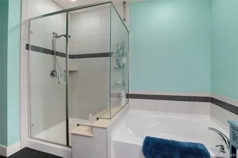 a bathroom with a bathtub and a shower
