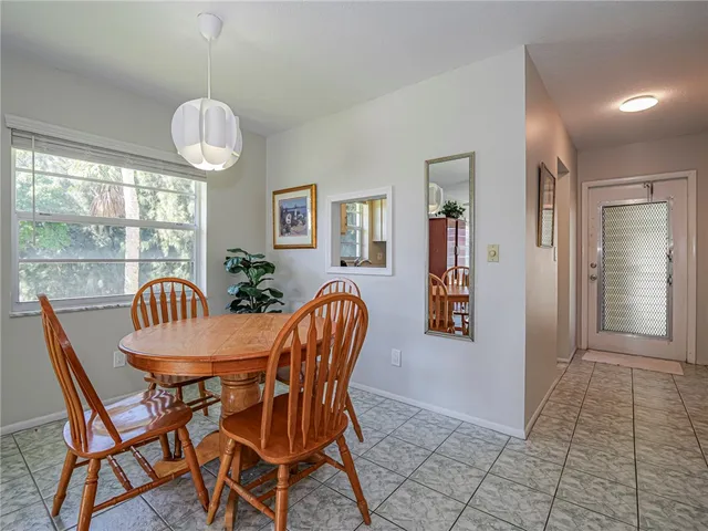 a dining room filled chandelier and wooden floor