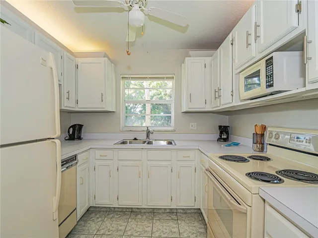 a kitchen with stainless steel appliances granite countertop a sink a stove and cabinets
