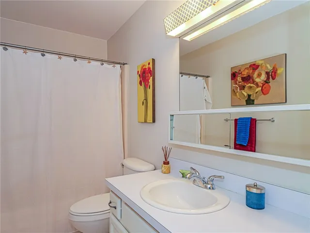 a bathroom with a sink a mirror and a toilet