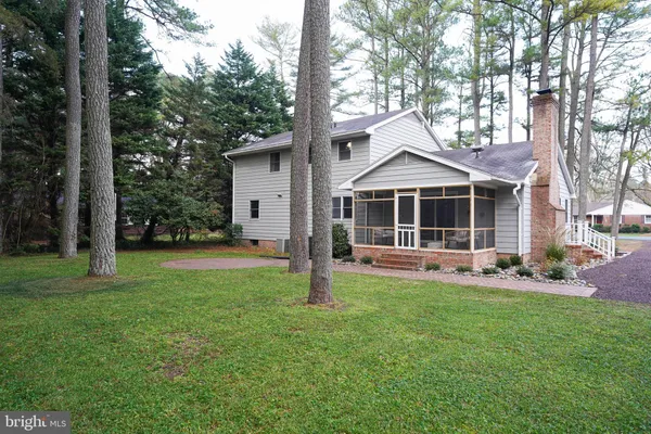 a view of a hallway with wooden floor and furniture