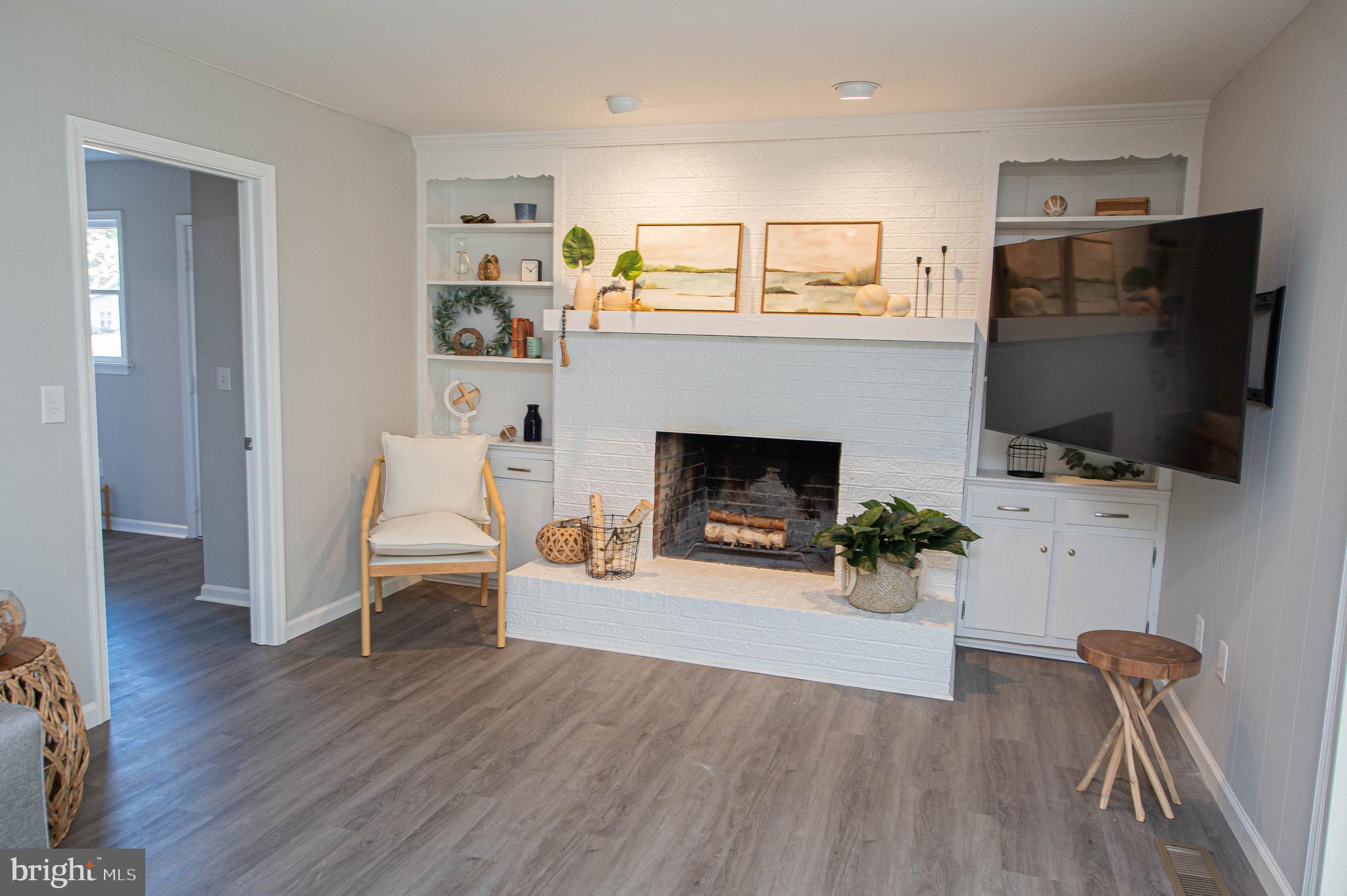 414 Pine Bluff Road Salisbury, MD 21801 - Photo 26 of 91 a living room with furniture a flat screen tv and a fireplace