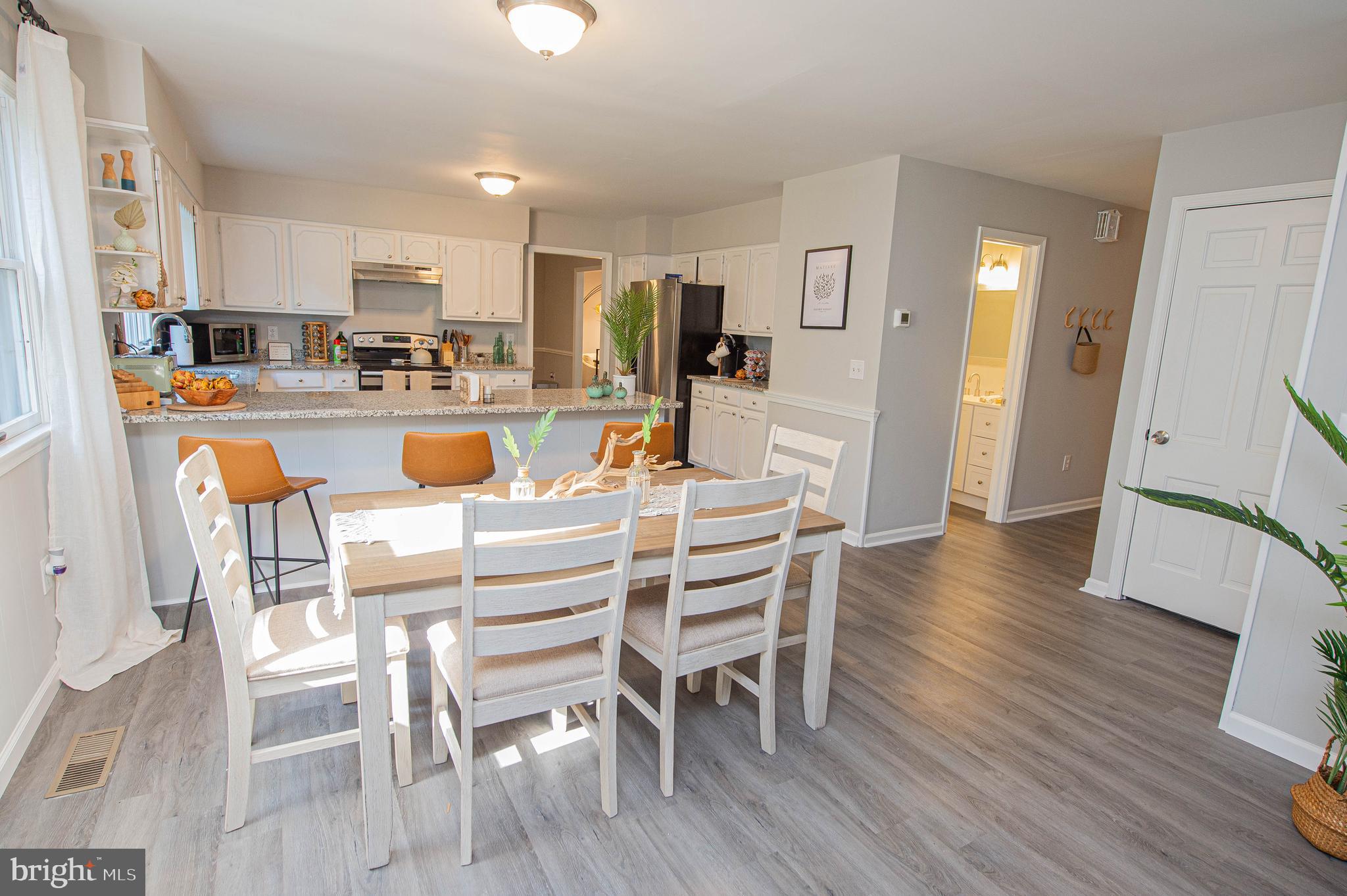 414 Pine Bluff Road Salisbury, MD 21801 - Photo 28 of 91 a view of a dining room with furniture and wooden floor
