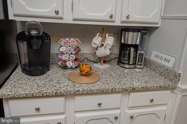 a living room with a bed furniture and a flat screen tv