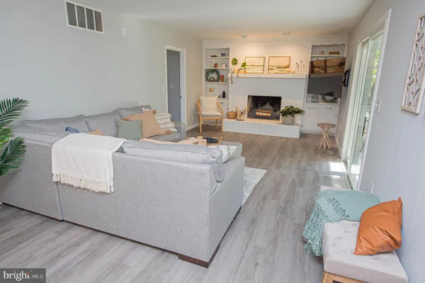 a room with wooden floor and furniture