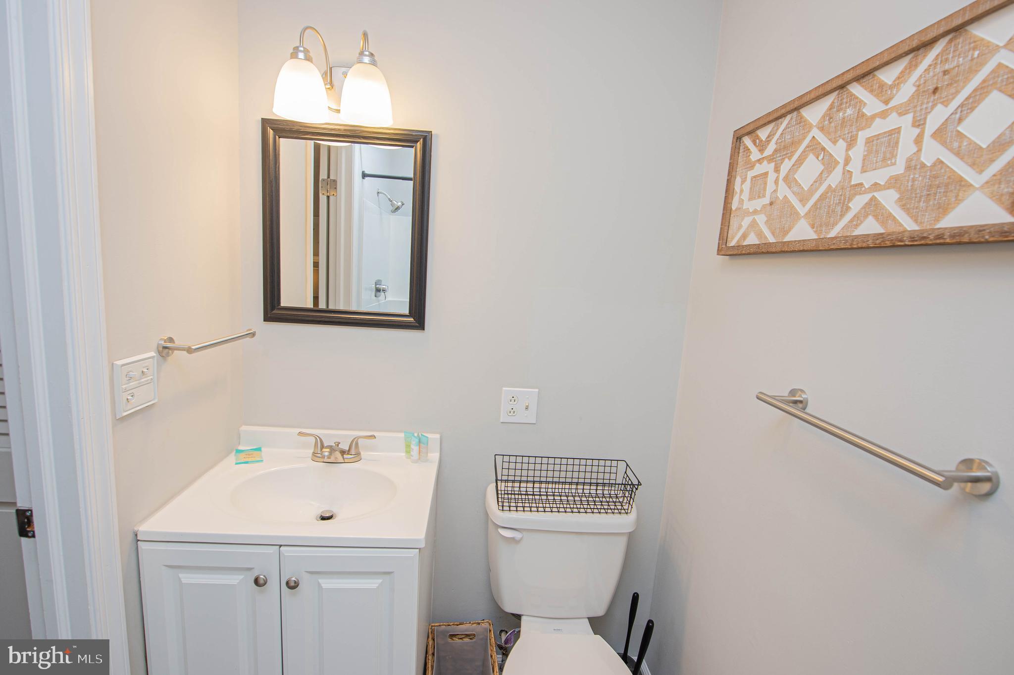414 Pine Bluff Road Salisbury, MD 21801 - Photo 47 of 91 a bathroom with a toilet a sink and mirror