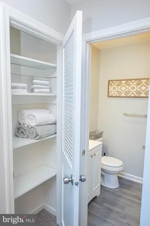 a bathroom with a granite countertop sink toilet and shower curtains