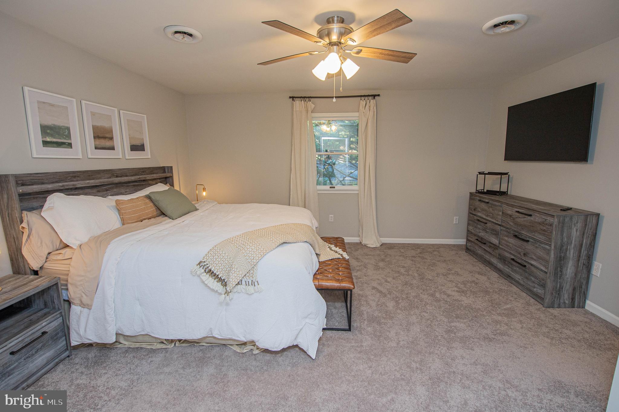 414 Pine Bluff Road Salisbury, MD 21801 - Photo 84 of 91 a spacious bedroom with a bed and a flat screen tv