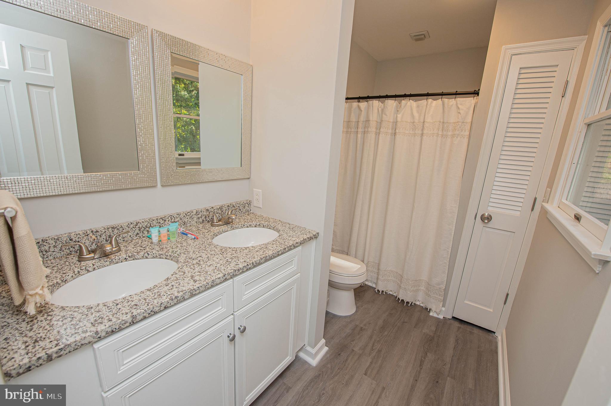 414 Pine Bluff Road Salisbury, MD 21801 - Photo 88 of 91 a bathroom with a granite countertop sink toilet and shower curtains