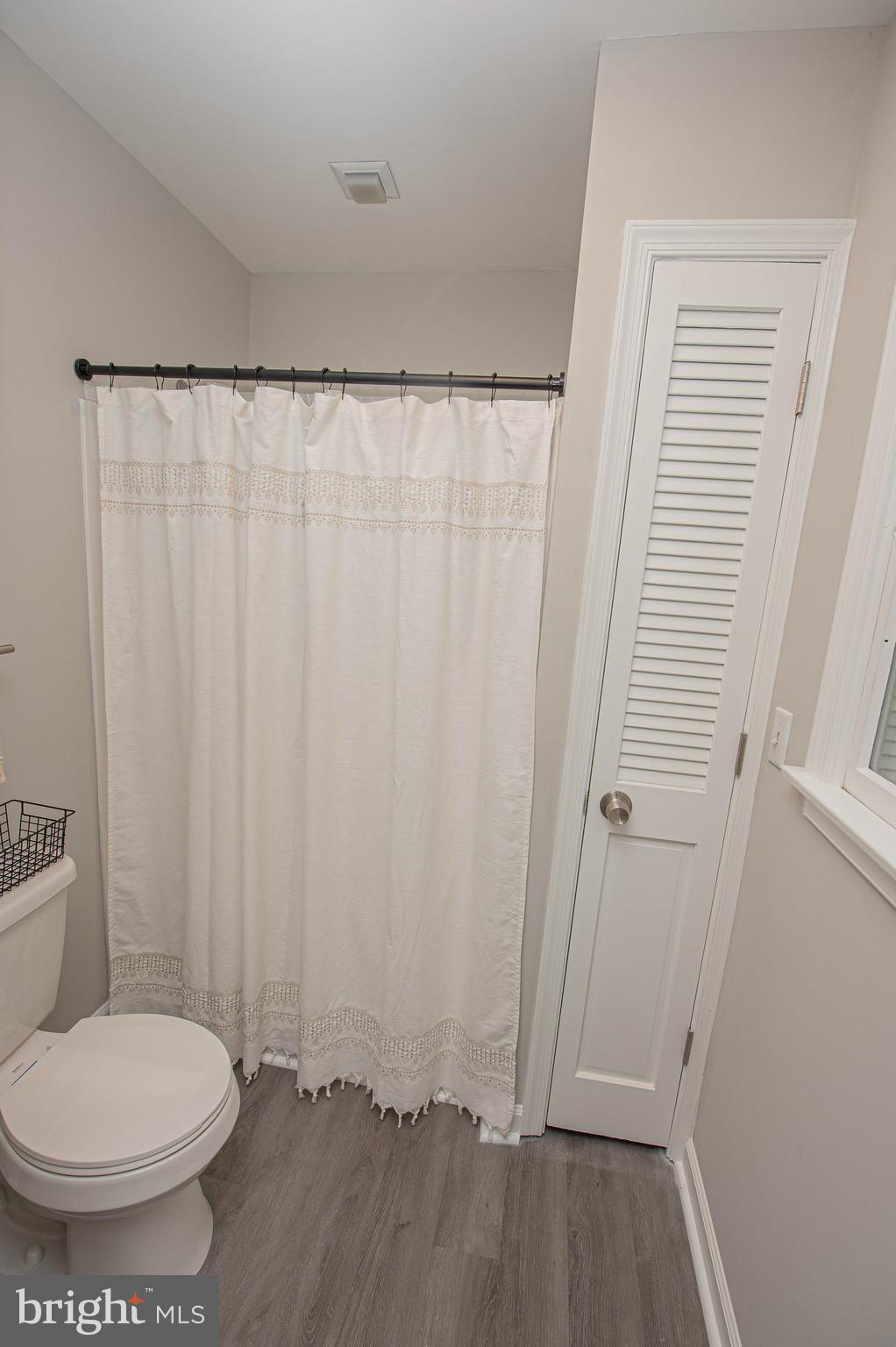 414 Pine Bluff Road Salisbury, MD 21801 - Photo 89 of 91 a bathroom with a toilet and a shower curtain