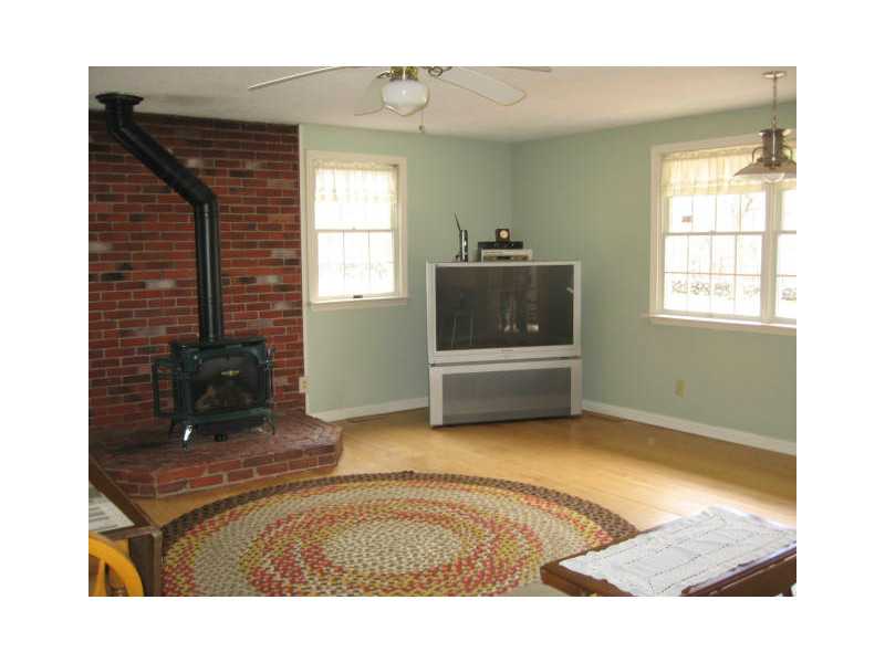 1495 Chopmist Hill Road Scituate, RI 02857 - Photo 11 of 25 Den/Family/Great Room. Family room with wide plank hardwoods and gas wood stove for those cold winter nights!