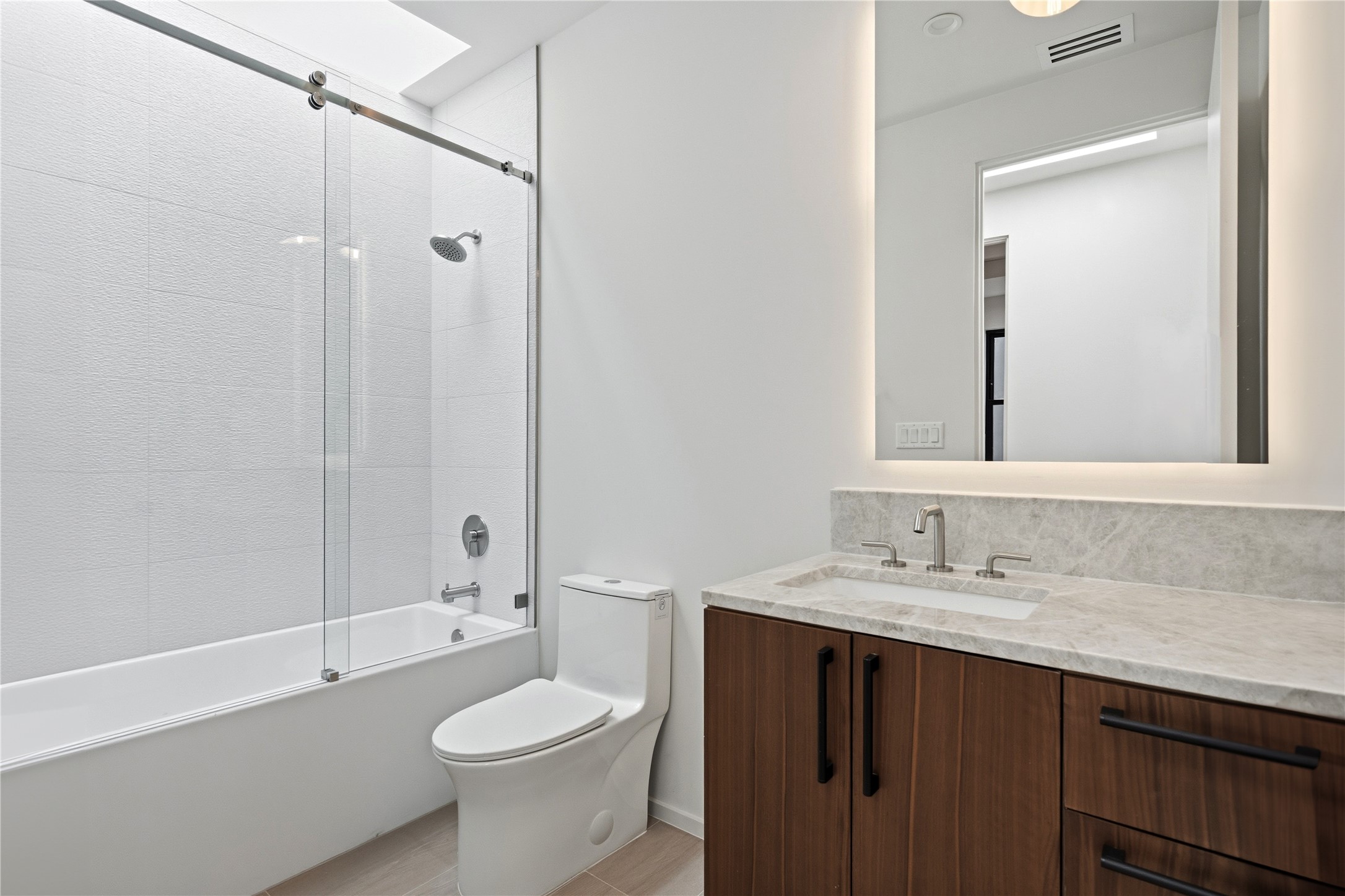 1912 South 3rd Street Austin, TX 78704 - Photo 15 of 21 a bathroom with a sink a toilet a mirror and shower