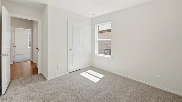 an empty room with windows and closet