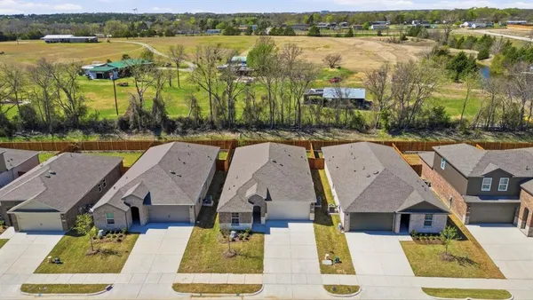 an aerial view of residential house with outdoor space and lake view
