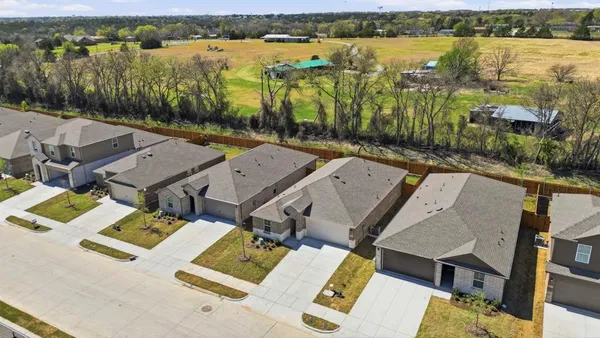 an aerial view of residential houses with outdoor space