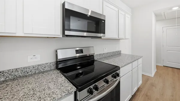 a kitchen with a sink and granite top
