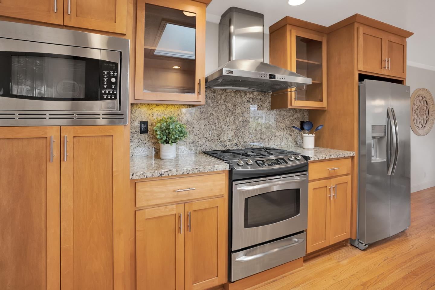 830 Cherrystone Drive Los Gatos, CA 95032 - Photo 12 of 28 a kitchen with stainless steel appliances granite countertop a stove a microwave and a refrigerator