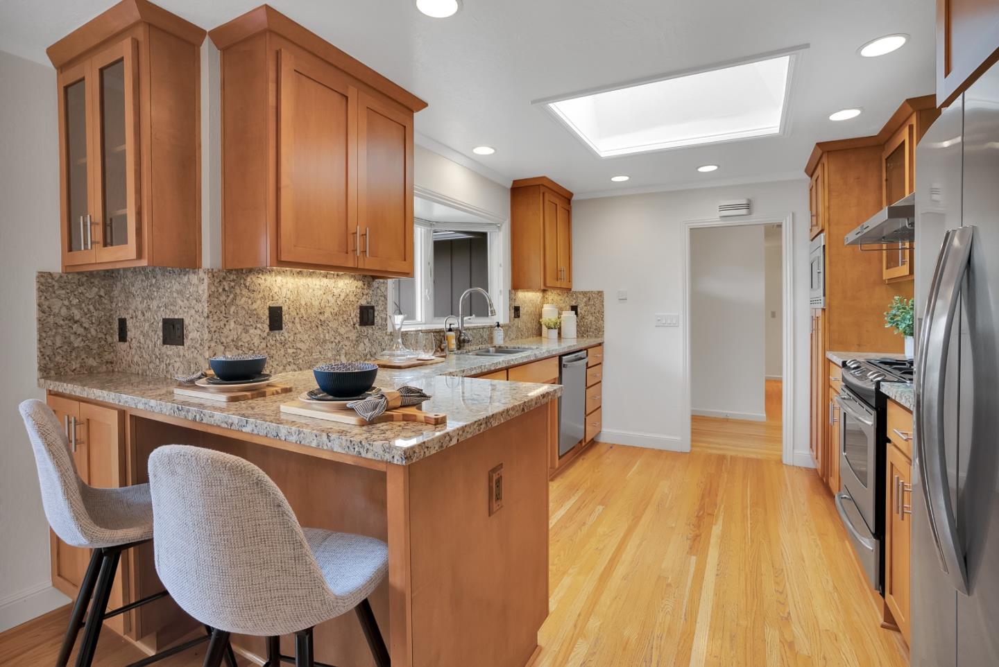 830 Cherrystone Drive Los Gatos, CA 95032 - Photo 15 of 28 a kitchen with stainless steel appliances granite countertop a sink a stove a refrigerator and island
