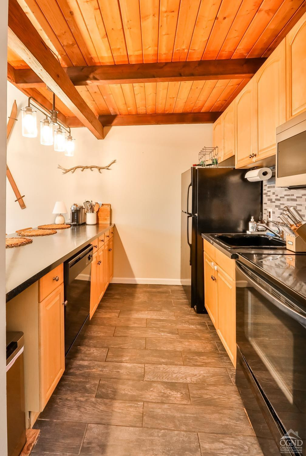 110-2 Highridge Road Windham, NY 12439 - Photo 26 of 48 a kitchen with stainless steel appliances a stove top oven a sink and a microwave