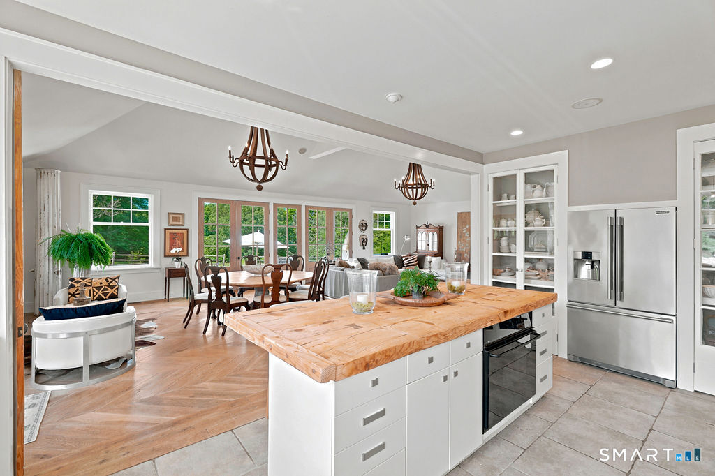 261-1 Grassy Hill Road Lyme, CT 06371 - Photo 11 of 40 The well-appointed kitchen opens to the dining and gathering spaces, providing a seamless blend of everyday comfort and easy entertaining.