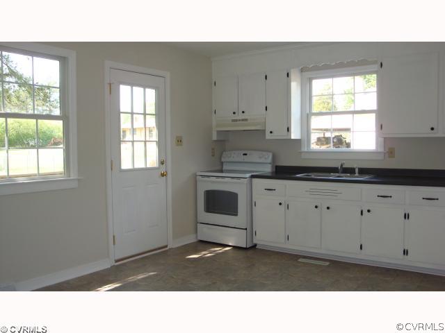 15312 Saddlebrook Road Chesterfield, VA 23838 - Photo 3 of 8 a kitchen with white cabinets and window