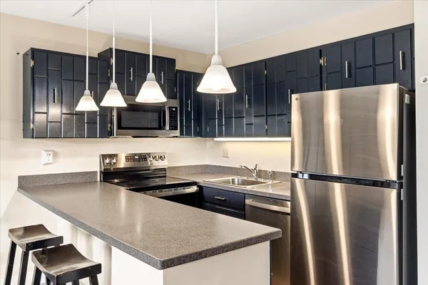 a kitchen with a refrigerator a sink and a stove