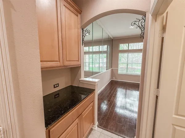 a view of a sink and dishwasher with wooden floor