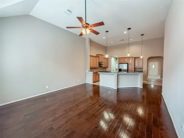 a view of a kitchen with a sink wooden floor and a refrigerator