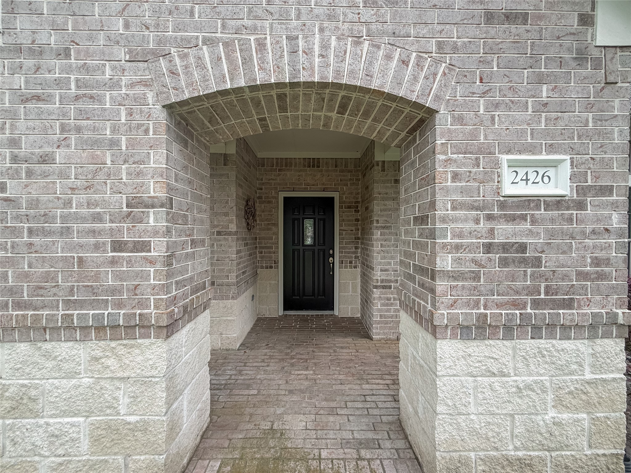 2426 Clippers Square Houston, TX 77058 - Photo 2 of 34 a stone house with a potted plant