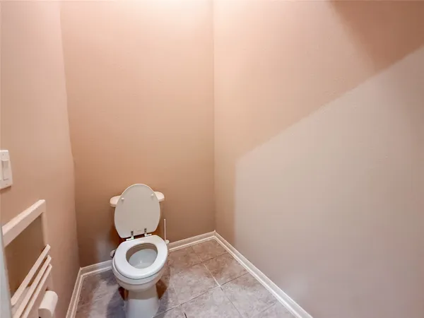 an empty room with ceiling fan and window