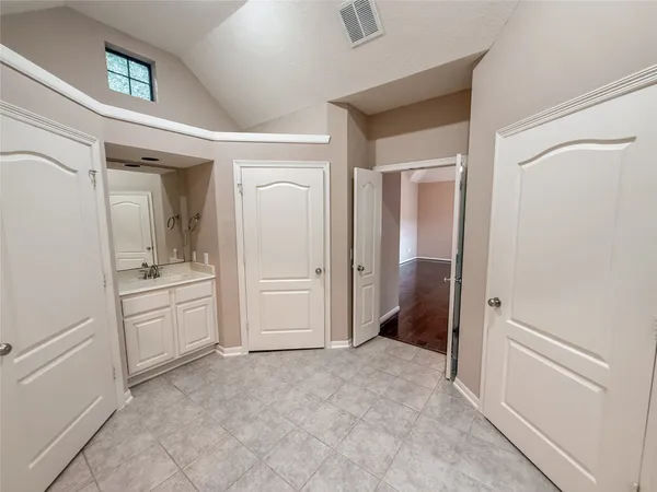a bathroom with a tub sink and mirror