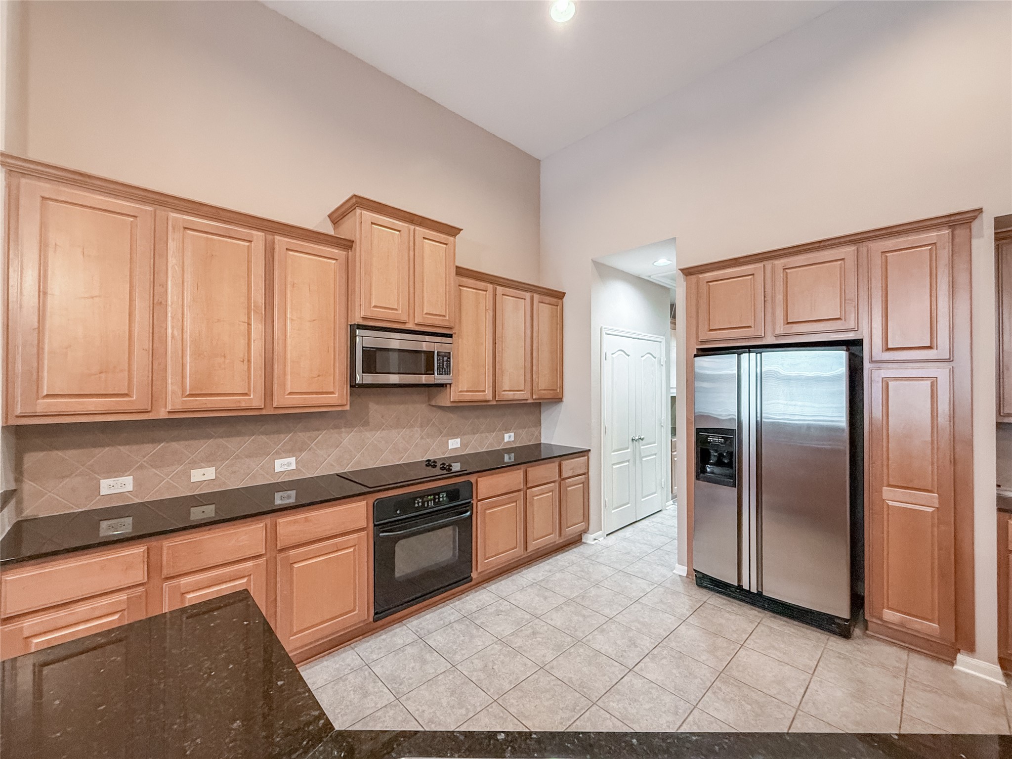 2426 Clippers Square Houston, TX 77058 - Photo 7 of 34 a kitchen with stainless steel appliances granite countertop a stove a sink and a refrigerator