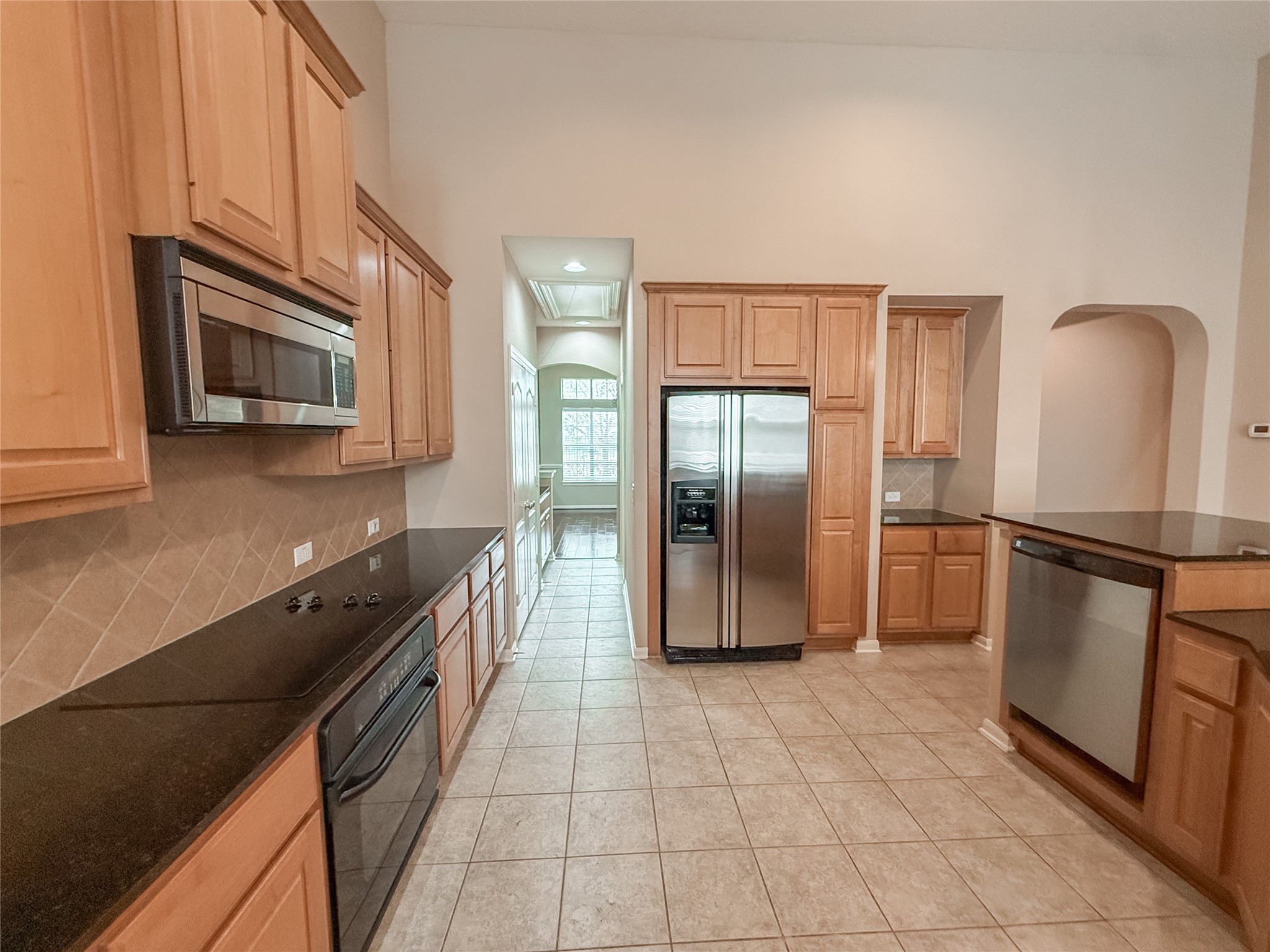 2426 Clippers Square Houston, TX 77058 - Photo 9 of 34 a kitchen with stainless steel appliances granite countertop a refrigerator a stove a sink and a microwave