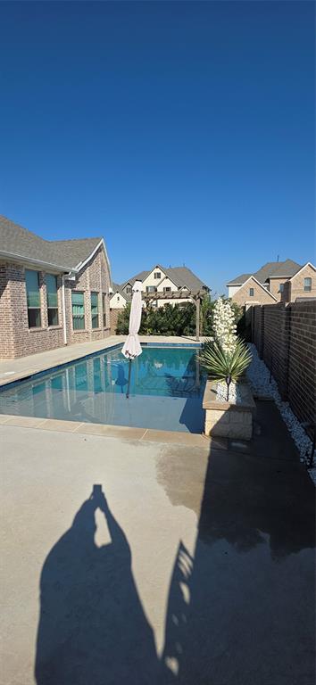 2000 Johnson Road Mansfield, TX 76063 - Photo 26 of 27 Rectangular swimming pool with surrounding concrete patio, bordered by a brick privacy wall