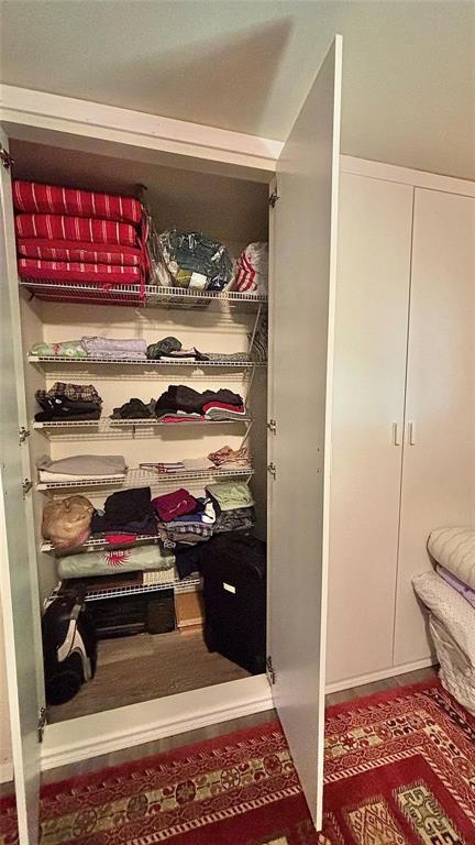 680 Choctaw Quitman, TX 75783 - Photo 18 of 33 a view of walk in closet with clothes and shoes