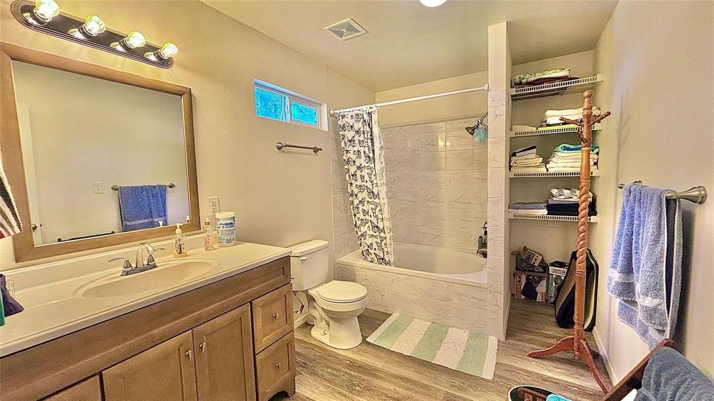 680 Choctaw Quitman, TX 75783 - Photo 19 of 33 a bathroom with a sink a toilet a mirror and shower