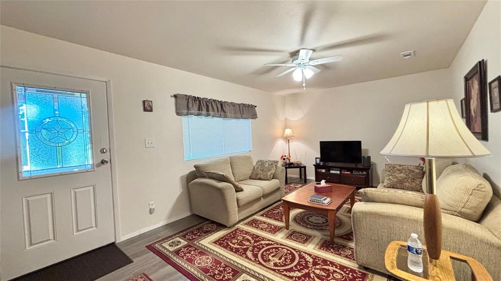 680 Choctaw Quitman, TX 75783 - Photo 7 of 33 a living room with furniture a flat screen tv and a window