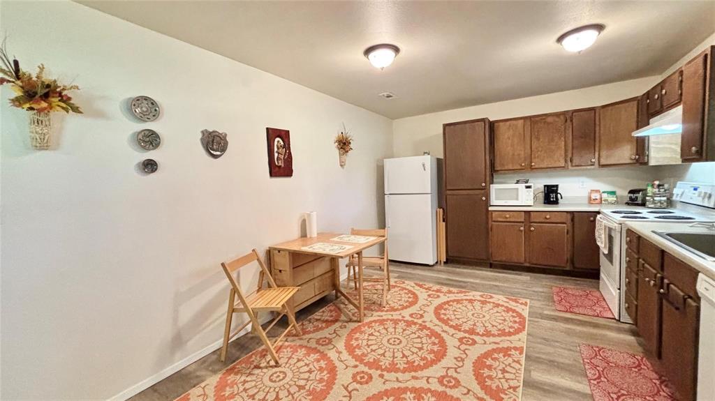 680 Choctaw Quitman, TX 75783 - Photo 9 of 33 a kitchen with a sink a refrigerator and cabinets