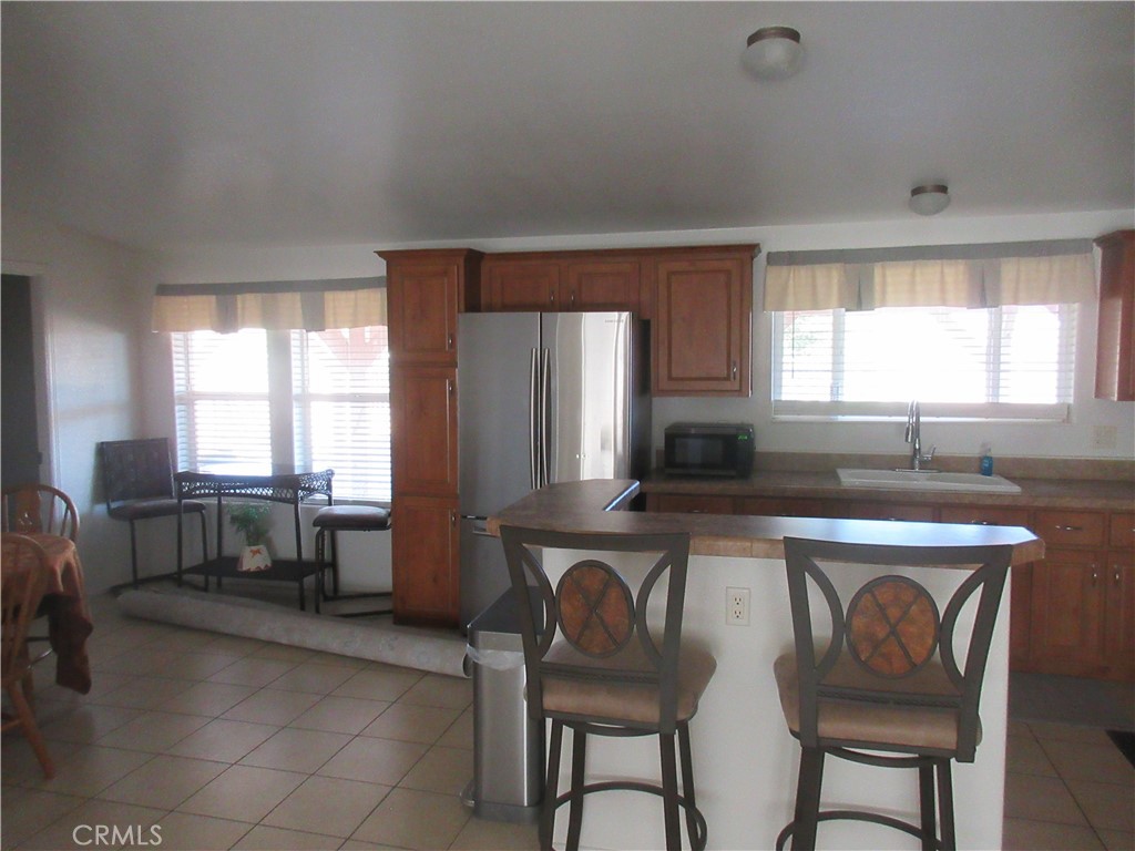 Undisclosed Address Phelan, CA 92371 - Photo 14 of 42 a kitchen with a table chairs sink and cabinets