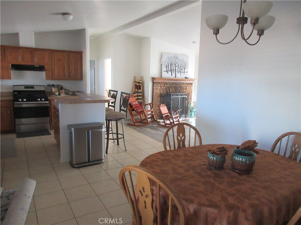 Undisclosed Address Phelan, CA 92371 - Photo 15 of 42 a kitchen with a table chairs and a refrigerator