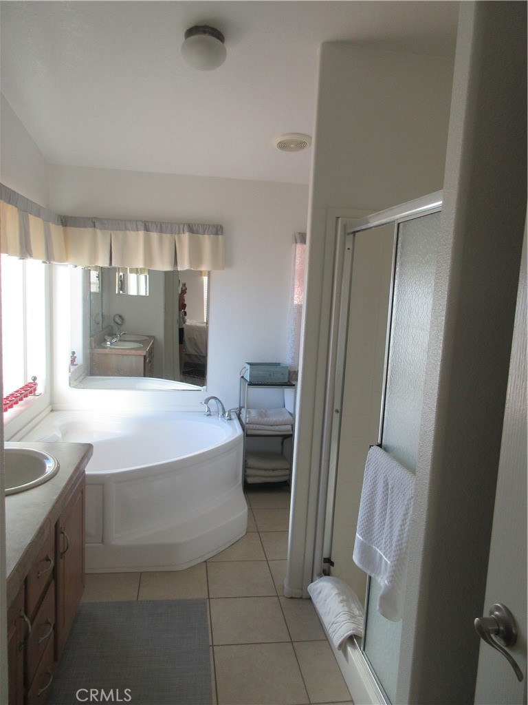 Undisclosed Address Phelan, CA 92371 - Photo 20 of 42 a spacious bathroom with a bathtub sink and toilet