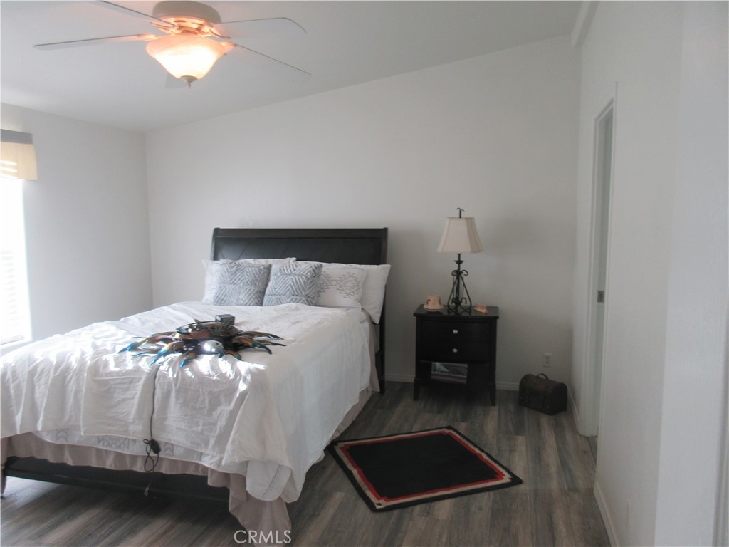 Undisclosed Address Phelan, CA 92371 - Photo 22 of 42 a bedroom with a bed and a chandelier