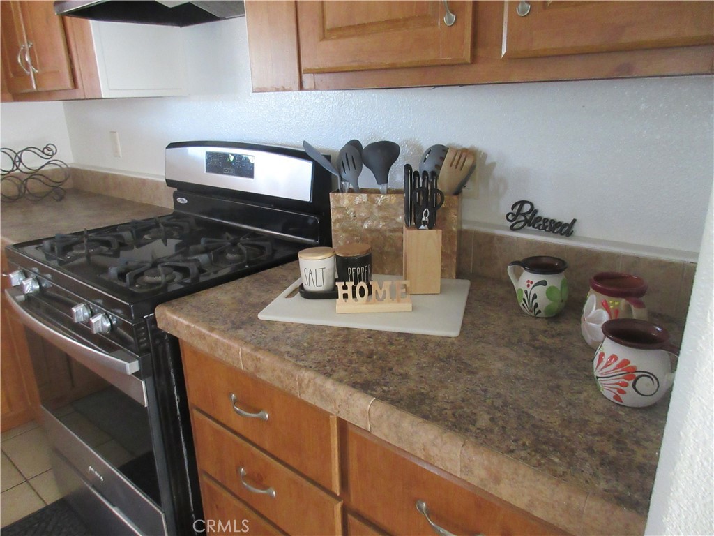Undisclosed Address Phelan, CA 92371 - Photo 24 of 42 a kitchen with a stove and cabinets