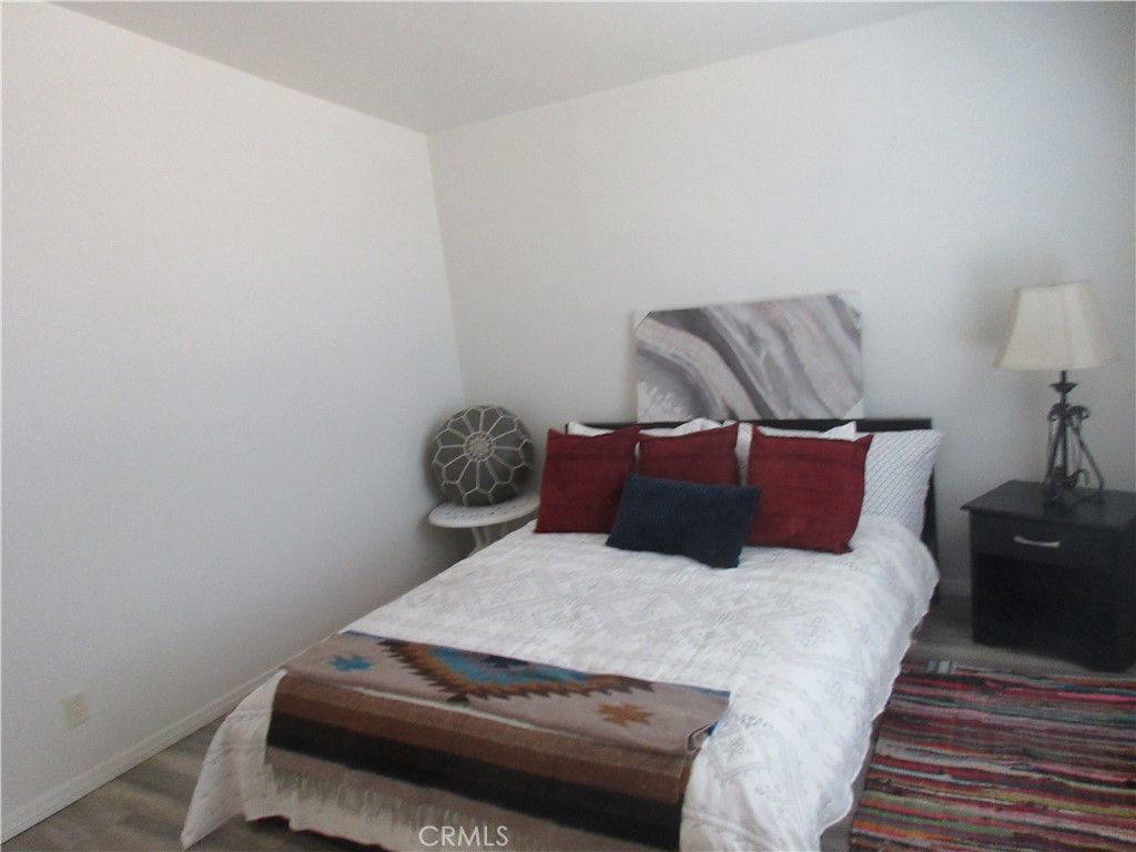 Undisclosed Address Phelan, CA 92371 - Photo 32 of 42 a bedroom with a bed and a night stand
