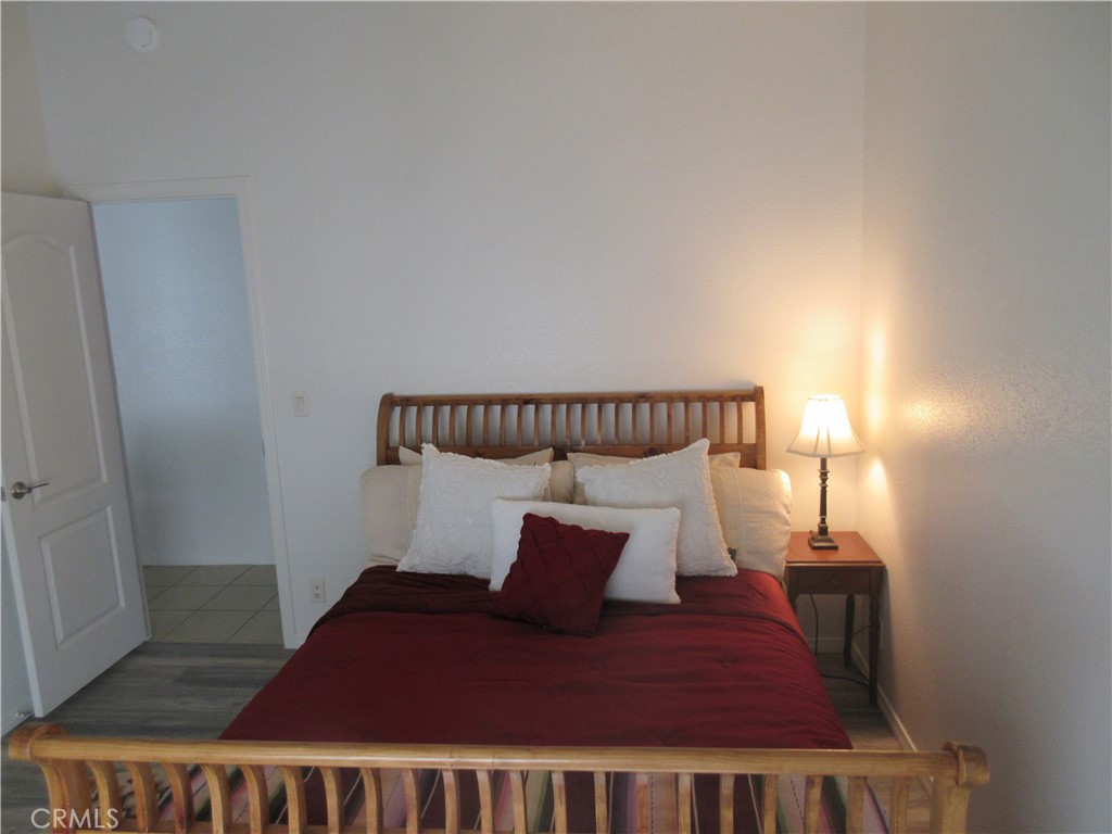 Undisclosed Address Phelan, CA 92371 - Photo 35 of 42 a bedroom with a bed and a night stand