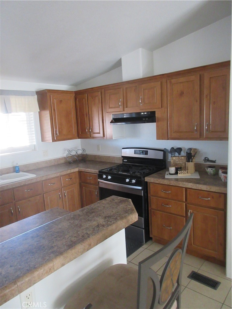 Undisclosed Address Phelan, CA 92371 - Photo 40 of 42 a kitchen with granite countertop a sink cabinets and stainless steel appliances