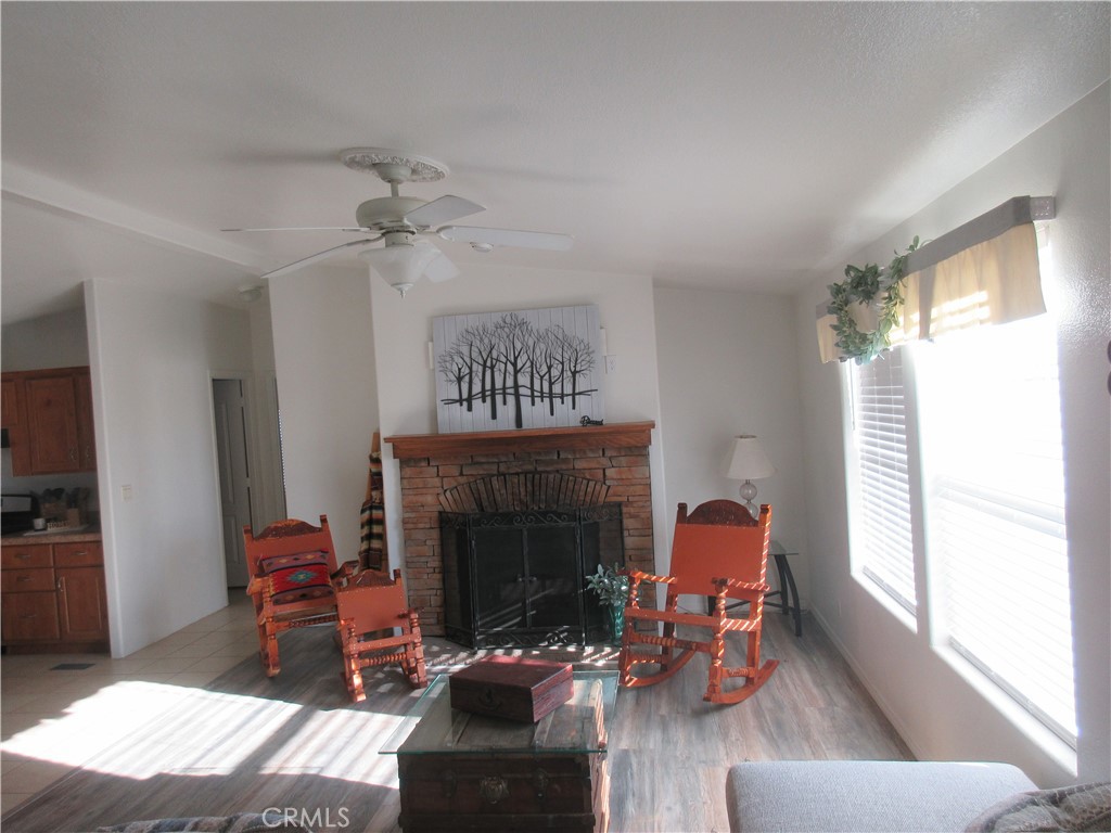 Undisclosed Address Phelan, CA 92371 - Photo 7 of 42 a living room with furniture a fireplace and a window