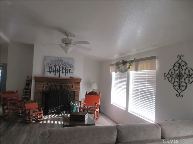 a living room with furniture a fireplace and a chandelier