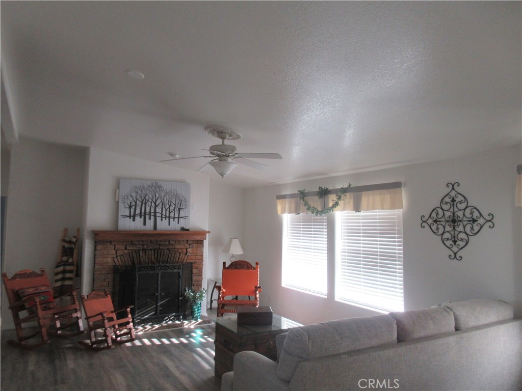 Undisclosed Address Phelan, CA 92371 - Photo 9 of 42 a living room with furniture large window and fireplace