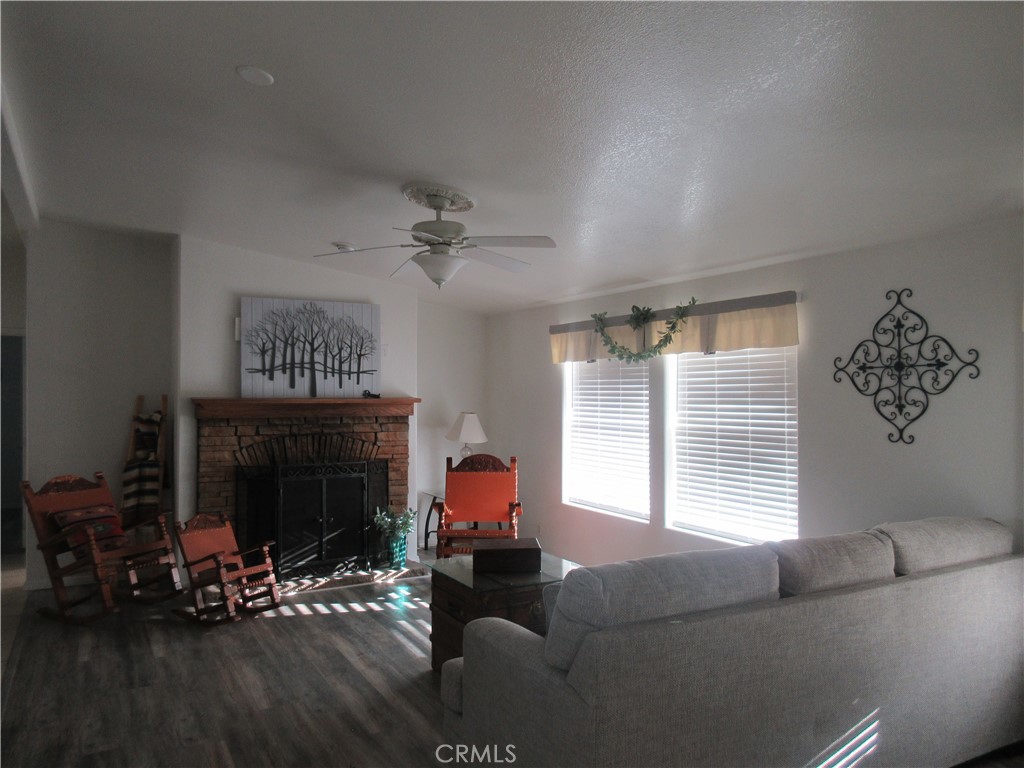 Undisclosed Address Phelan, CA 92371 - Photo 10 of 42 a living room with furniture and a fireplace